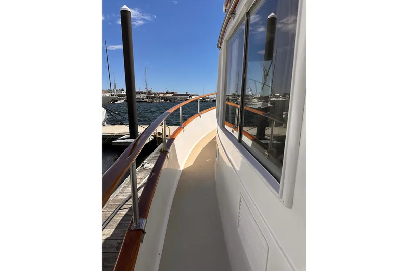 Slide: The Image of Side deck view of a 1994 Grand Banks 42 Classic yacht at a marina. - 7
