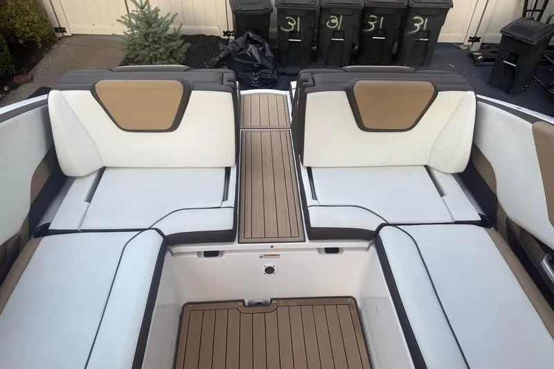 Slide: The Image of 2021 Yamaha Boats 252SD interior with white and tan seating, featuring sleek design. - 3