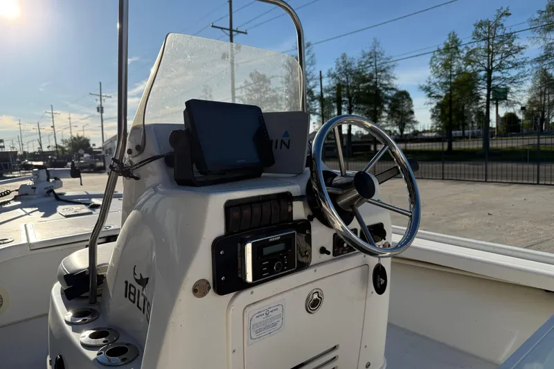 Slide: The Image of 2010 Mako 18 LTS boat console with steering wheel and navigation equipment. - 10