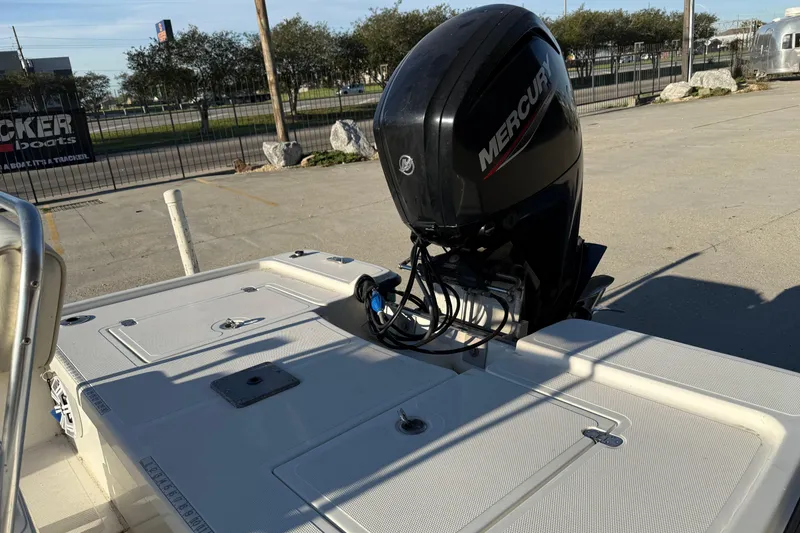 Slide: The Image of 2010 Mako 18 LTS boat with Mercury outboard motor in a parking lot. - 11