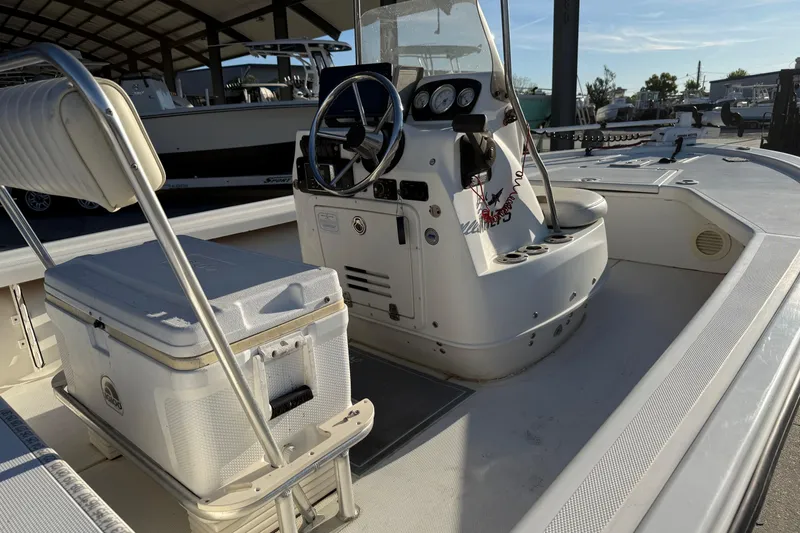 Slide: The Image of 2010 Mako 18 LTS boat interior with steering console and seating. - 13