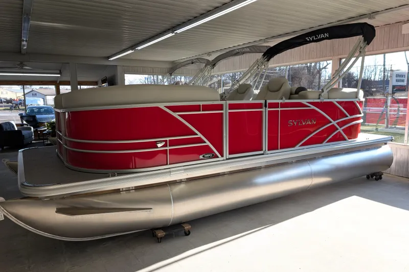 The Image of 2026 Sylvan Mirage 820 CLZ DH pontoon boat in showroom, featuring sleek red design. - 1