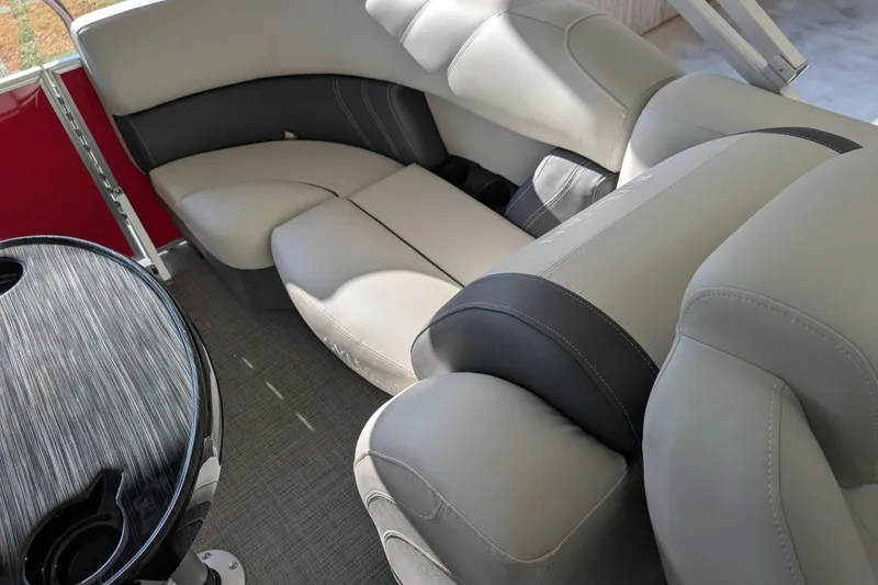 Slide: The Image of 2026 Sylvan Mirage 820 CLZ DH boat interior with plush seating and sleek table design. - 14