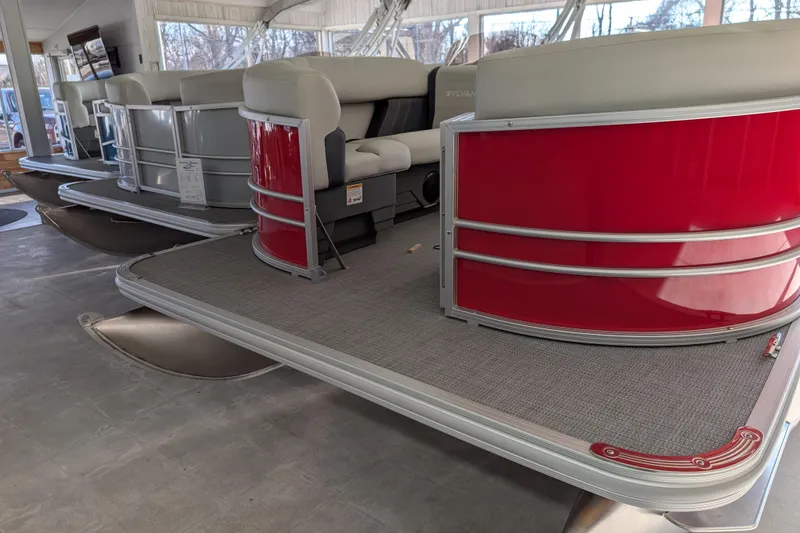 Slide: The Image of 2026 Sylvan Mirage 820 CLZ DH pontoon boat with red exterior in showroom. - 3