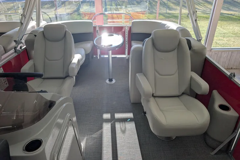 Slide: The Image of Interior of 2026 Sylvan Mirage 820 CLZ DH pontoon boat with plush seating and table. - 6