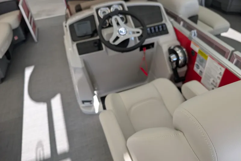 Slide: The Image of Interior of 2026 Sylvan Mirage 820 CLZ DH boat with steering wheel and controls. - 7