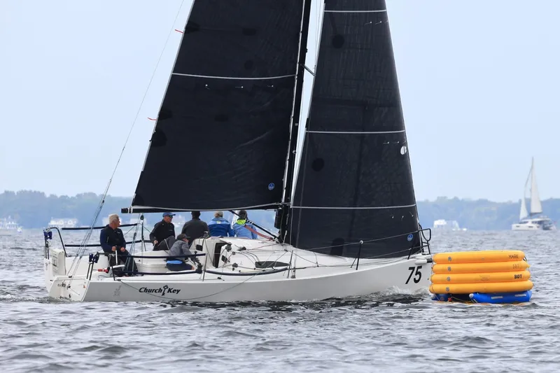 The Image of 2015 J Boats J/88 sailboat racing near buoy on open water. - 0