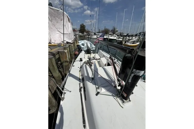 Slide: The Image of 2015 J Boats J/88 sailboat docked at marina under blue sky. - 11
