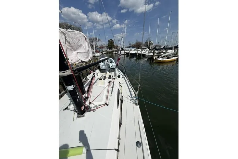 Slide: The Image of 2015 J Boats J/88 sailboat docked in a marina under a blue sky. - 12