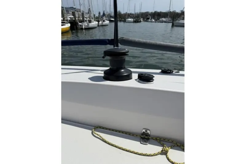 Slide: The Image of 2015 J Boats J/88 sailboat deck with winch and rope, docked in marina. - 14