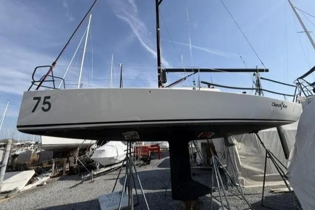 Slide: The Image of 2015 J Boats J/88 sailboat on stands, hull number 75, in a marina. - 8