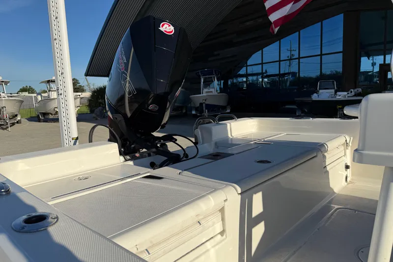 Slide: The Image of 2021 Ranger 2260 Bay Ranger boat with powerful outboard motor in a sunny marina. - 11