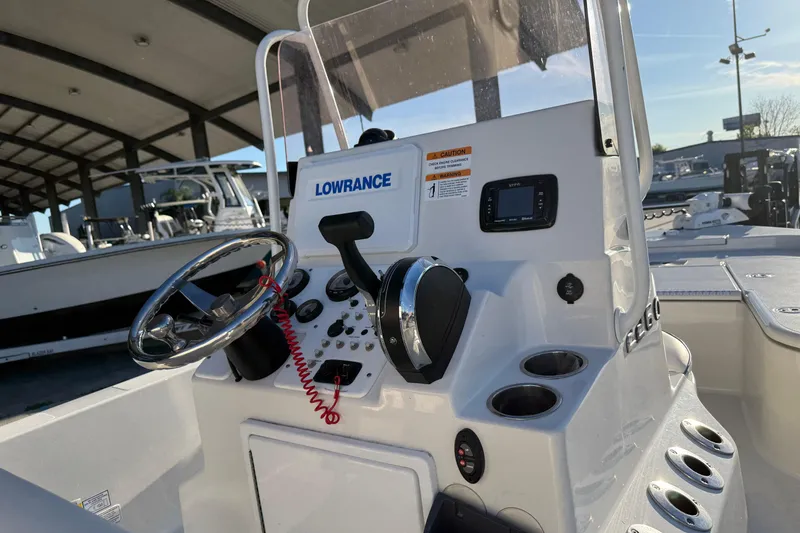 Slide: The Image of 2021 Ranger 2260 Bay Ranger boat console with steering wheel and Lowrance electronics. - 14