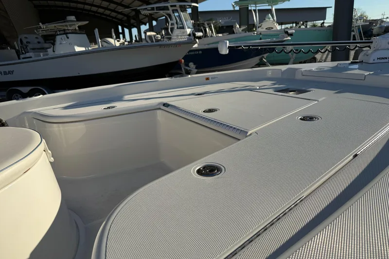 Slide: The Image of 2021 Ranger 2260 Bay Ranger boat deck with storage compartments in a marina setting. - 15