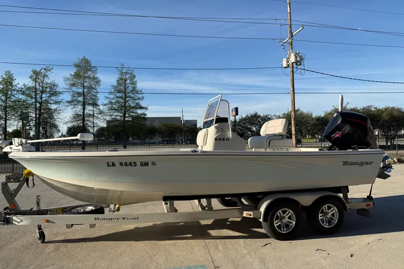 Slide: The Image of 2021 Ranger 2260 Bay Ranger boat on trailer, parked outdoors. - 3