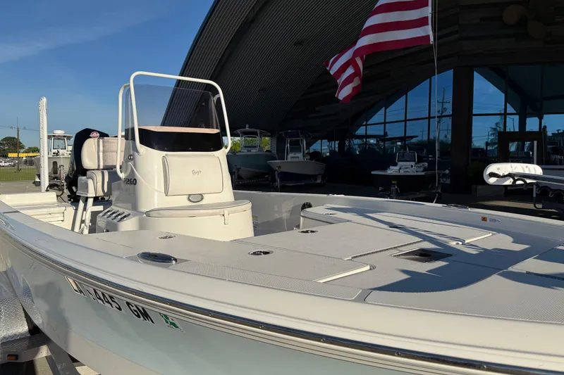 Slide: The Image of 2021 Ranger 2260 Bay Ranger boat with American flag, displayed outdoors. - 6