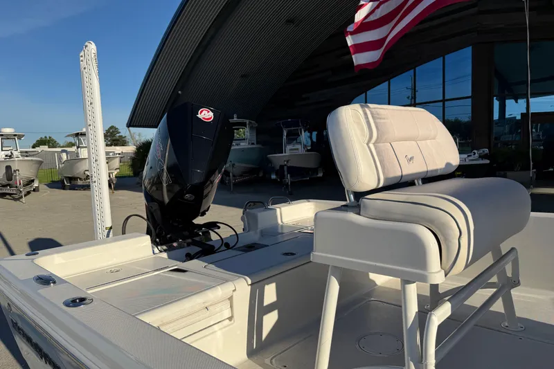 Slide: The Image of 2021 Ranger 2260 Bay Ranger boat with motor and seating, American flag in background. - 8