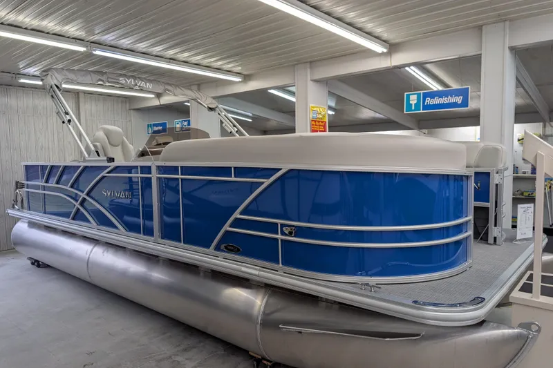 The Image of 2026 Sylvan Mirage Fish 8522 Party Fish pontoon boat in showroom, blue exterior. - 0