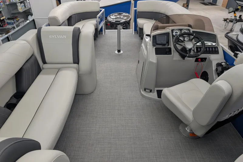 Slide: The Image of 2026 Sylvan Mirage Fish 8522 Party Fish boat interior with plush seating and modern helm. - 13