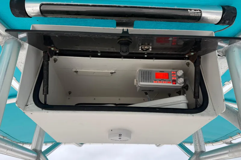 Slide: The Image of Open storage compartment on 2006 Pathfinder 2200 Tournament Edition boat with radio equipment. - 9