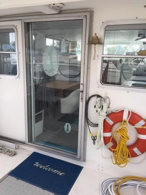 Slide: The Image of Entrance of 2000 Provincial 42 Pleasure Boat with lifebuoy and ropes. - 13