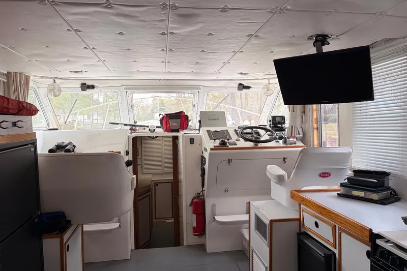 Slide: The Image of Interior of a 2000 Provincial 42 Pleasure Boat with helm, seating, and navigation equipment. - 16