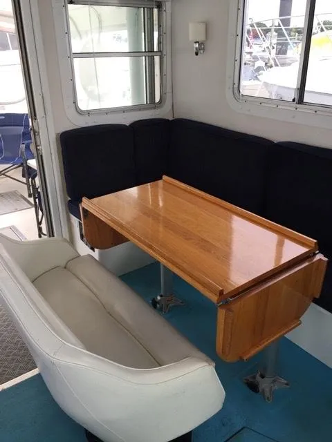 Slide: The Image of Interior of a 2000 Provincial 42 Pleasure Boat with wooden table. - 19