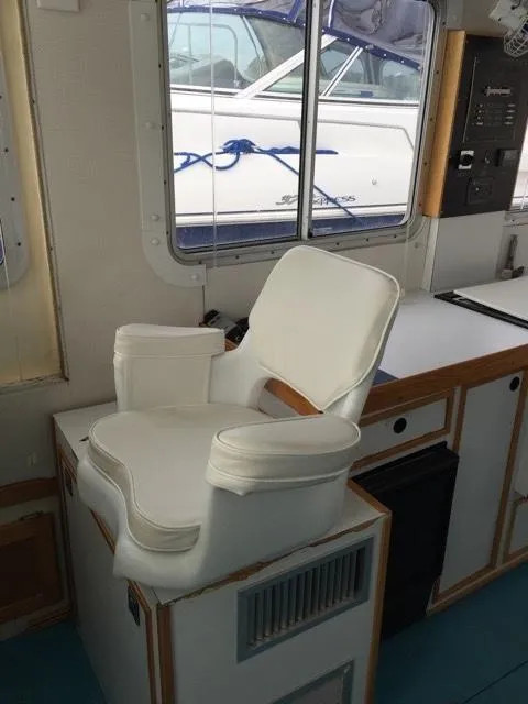 Slide: The Image of Interior of a 2000 Provincial 42 Pleasure Boat with white captain's chair. - 25