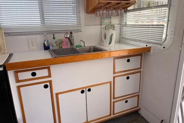 Slide: The Image of Kitchen area of a 2000 Provincial 42 Pleasure Boat with wooden cabinets and sink. - 27