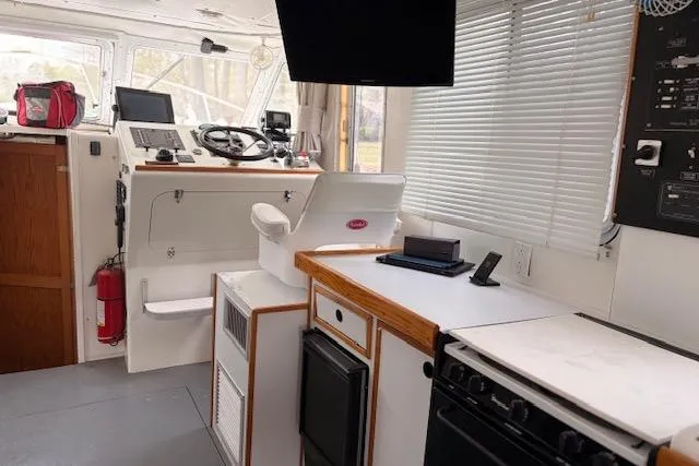 Slide: The Image of Interior of 2000 Provincial 42 Pleasure Boat with helm, appliances, and navigation equipment. - 28