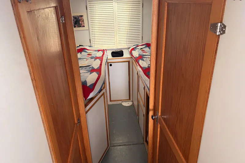 Slide: The Image of Interior of 2000 Provincial 42 Pleasure Boat with twin beds and wooden doors. - 40