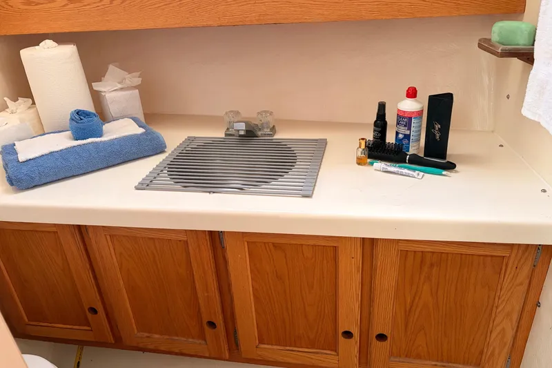 Slide: The Image of Bathroom vanity on 2000 Provincial 42 Pleasure Boat with toiletries and towels. - 42