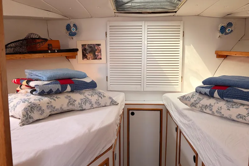 Slide: The Image of Cozy cabin interior of 2000 Provincial 42 Pleasure Boat with twin beds and nautical decor. - 63