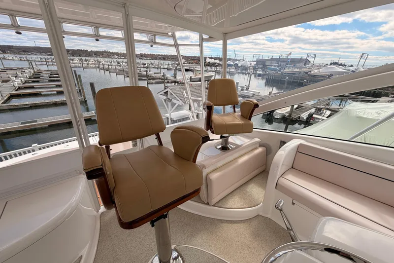 Slide: The Image of Interior of 2015 Viking 42 Open yacht with helm chairs and marina view. - 11
