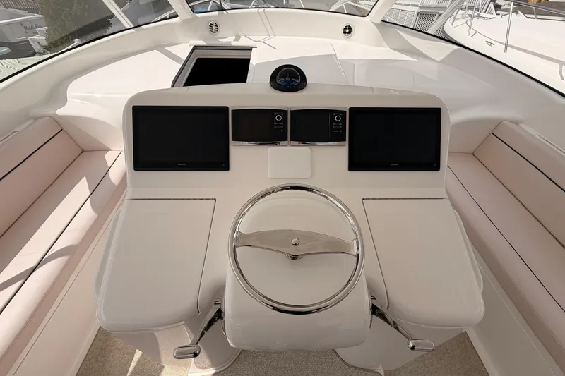 Slide: The Image of Helm of 2015 Viking 42 Open yacht with dual screens and steering wheel. - 14