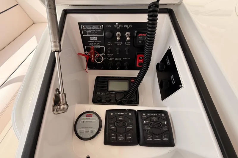 Slide: The Image of Control panel of a 2015 Viking 42 Open boat with various switches and instruments. - 16