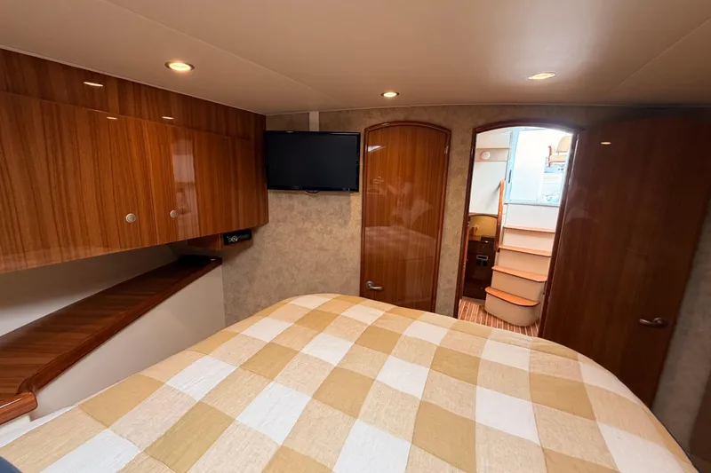 Slide: The Image of Luxurious cabin interior of 2015 Viking 42 Open yacht with wood finishes and cozy bedding. - 26