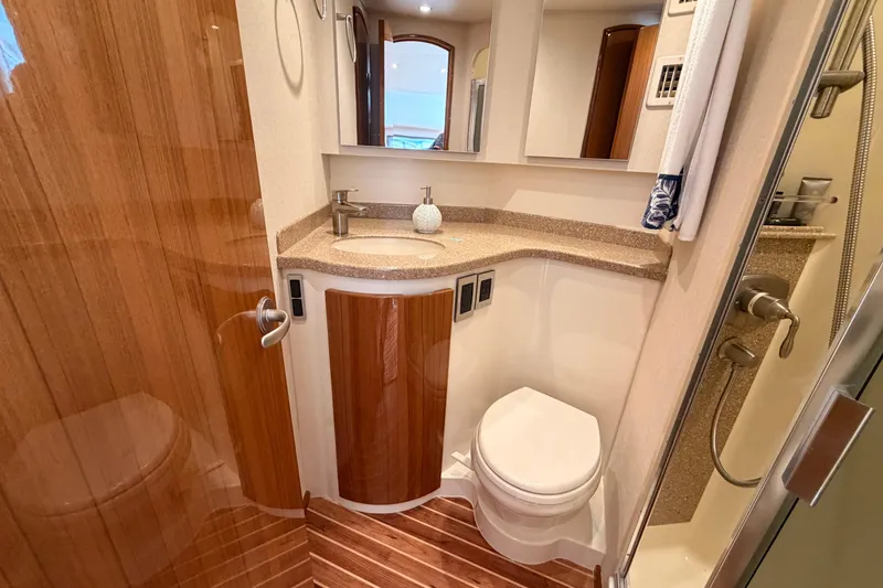 Slide: The Image of Luxurious bathroom in 2015 Viking 42 Open yacht with modern fixtures and wooden accents. - 27