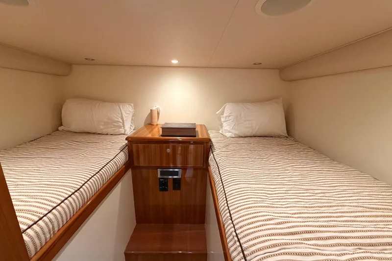 Slide: The Image of Twin beds in the cozy cabin of a 2015 Viking 42 Open yacht. - 28