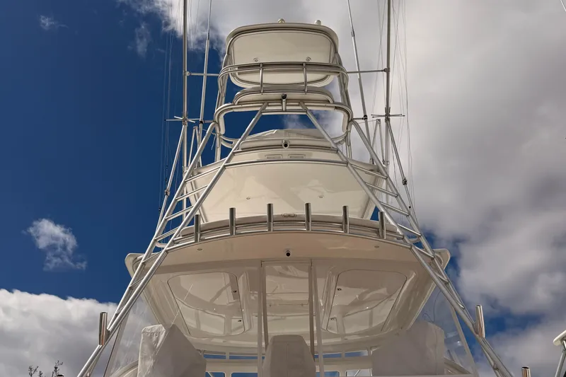 Slide: The Image of 2015 Viking 42 Open yacht tower against a cloudy blue sky. - 3