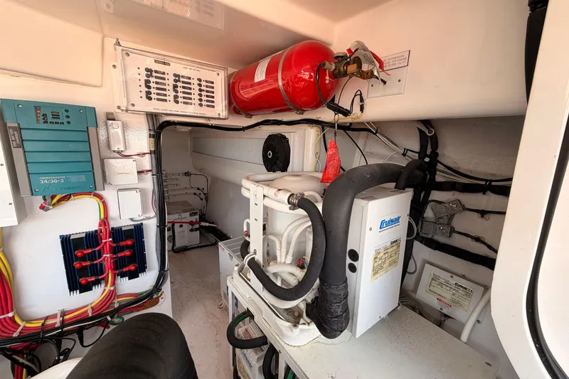 Slide: The Image of Engine room of 2015 Viking 42 Open yacht with electrical systems and fire extinguisher. - 30