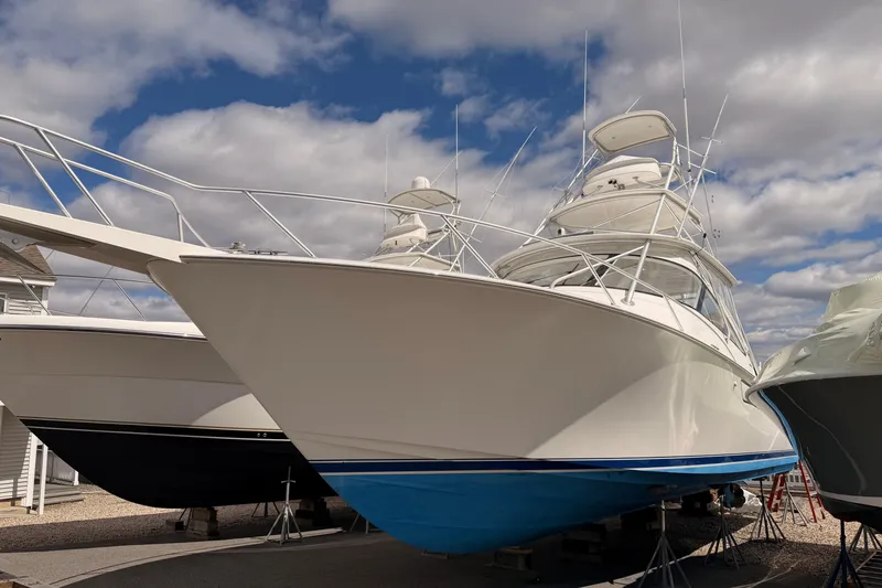 Slide: The Image of 2015 Viking 42 Open yacht on display under a cloudy sky. - 31