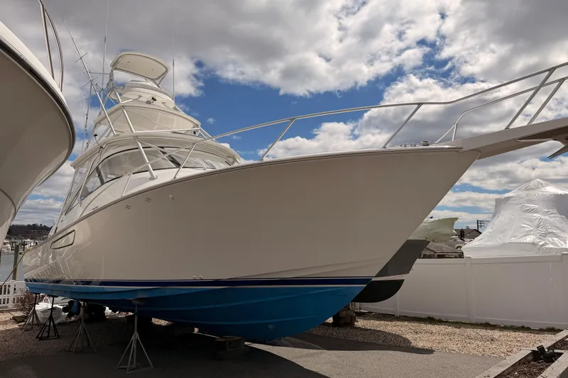Slide: The Image of 2015 Viking 42 Open yacht on display under a partly cloudy sky. - 32