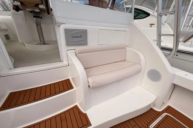 Slide: The Image of 2015 Viking 42 Open yacht interior with Garmin panel and cushioned seating. - 4