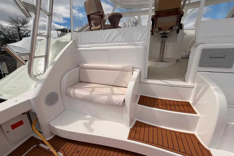 Slide: The Image of 2015 Viking 42 Open yacht interior with seating and Garmin equipment. - 5