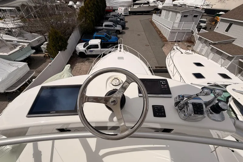 Slide: The Image of 2015 Viking 42 Open yacht helm with steering wheel and navigation controls. - 7