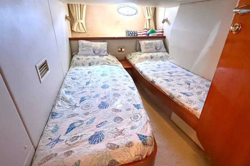 Slide: The Image of Twin cabin in 2002 Sunseeker Camargue 44 yacht with nautical-themed bedding. - 15