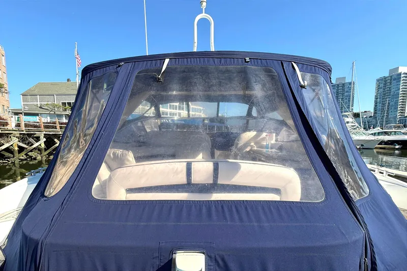 Slide: The Image of 2002 Sunseeker Camargue 44 yacht with blue canopy docked in marina. - 18