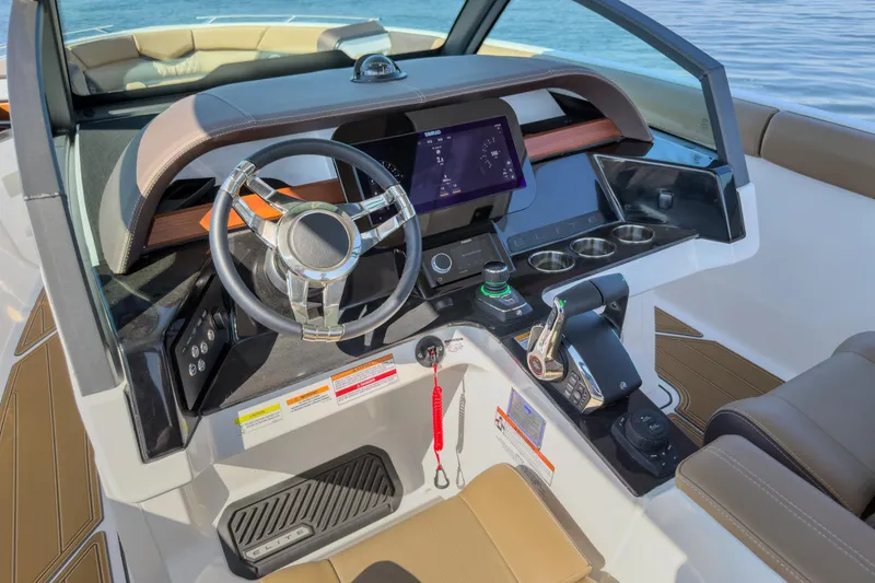 Slide: The Image of 2026 Monterey Elite 30 OB boat dashboard with modern controls and steering wheel. - 10