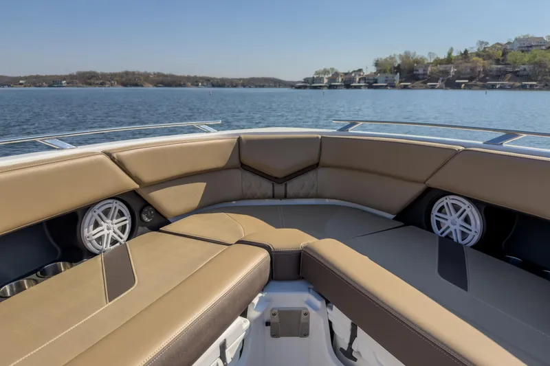 Slide: The Image of Luxurious seating on the 2026 Monterey Elite 30 OB boat, with scenic lake view. - 16